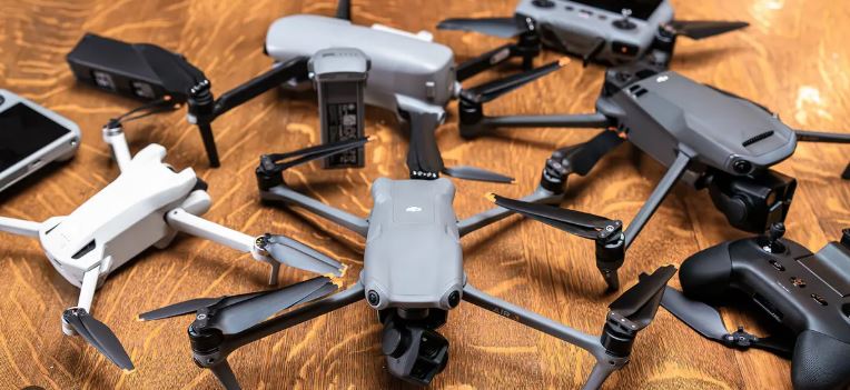 Modern drone flying against a clear sky during daylight testing.