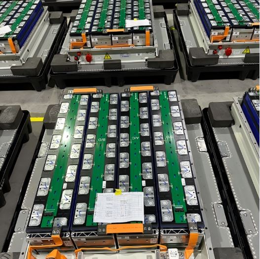 Close-up of advanced battery cells resting on a clean workbench.