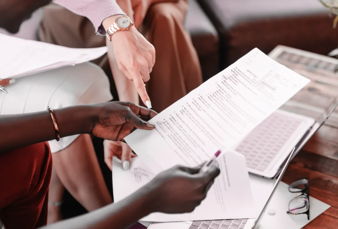 Engineers checking server dashboard displays on large monitors.