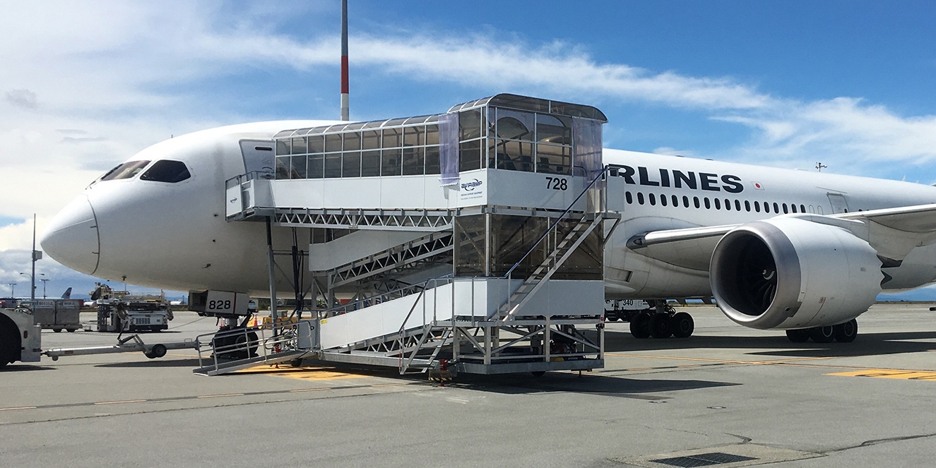 Modern passenger aircraft parked at a terminal gate.
