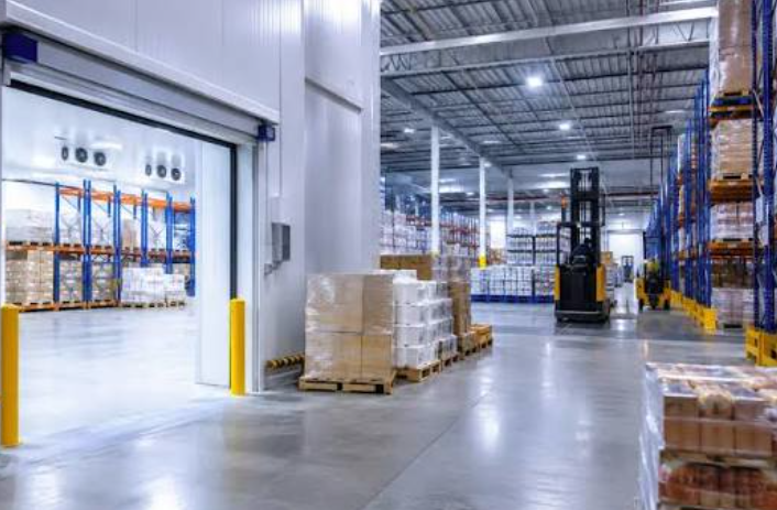 A modern commercial logistics warehouse interior with inventory.