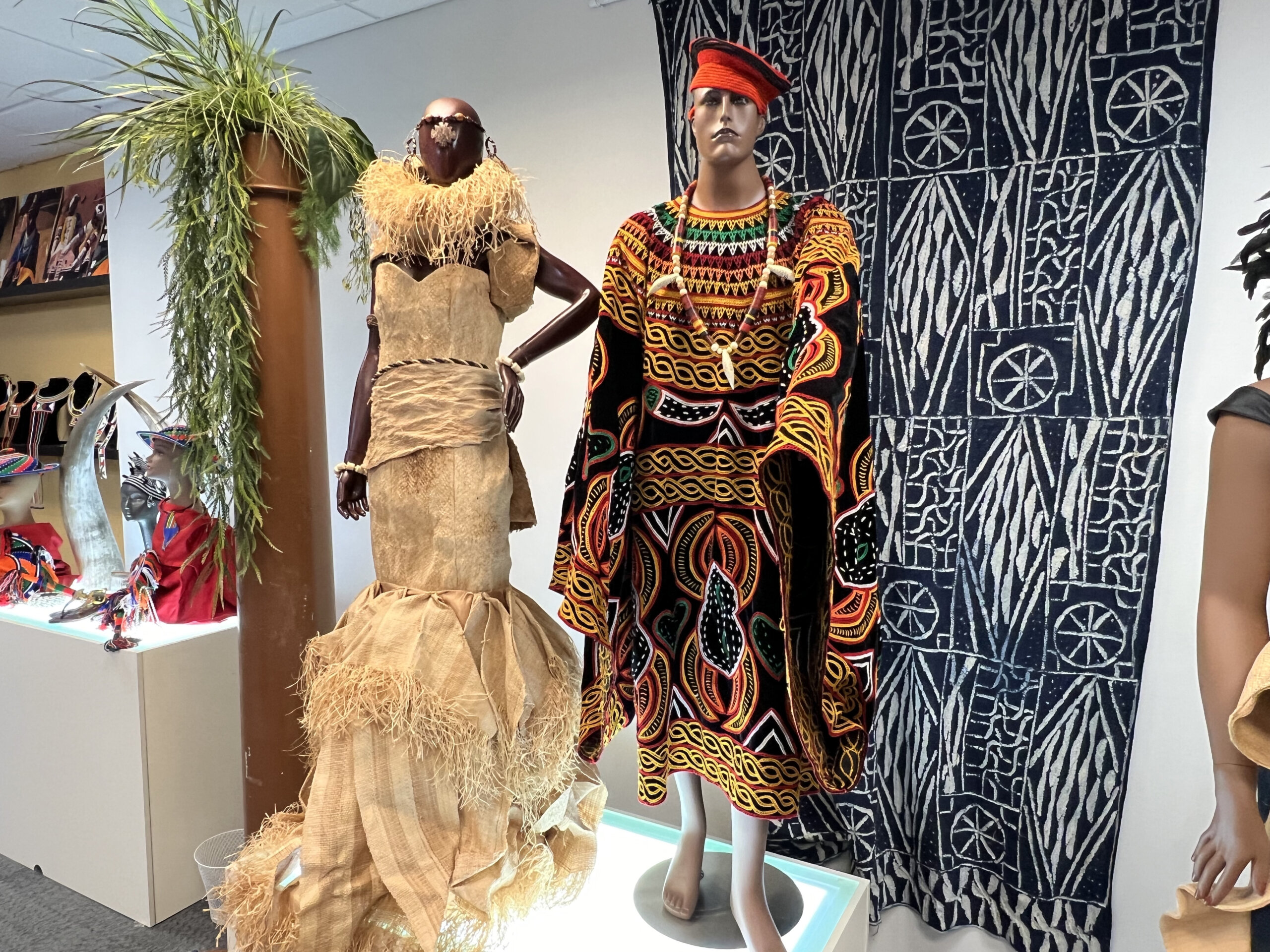 Handcrafted traditional textiles on display at an exhibition booth.