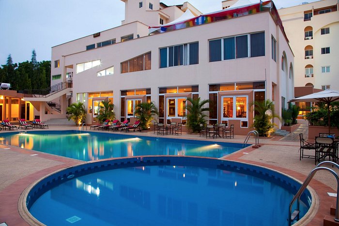 Exterior view of a hotel building and swimming pool in Accra, Ghana.