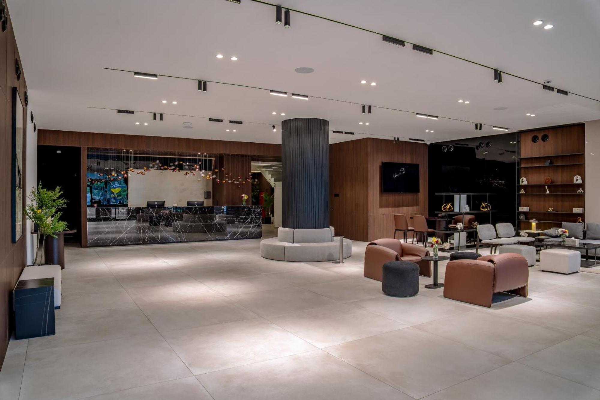 A spacious and modern hotel lobby featuring contemporary seating and bespoke woodwork in Cantonments, Accra, Ghana.