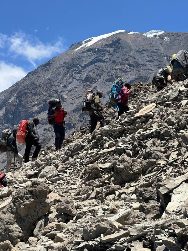 Porters guiding climbers along the slopes of Mount Kilimanjaro, Tanzania.