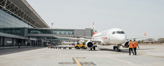 Ground crew members inspecting the new aircraft on the tarmac in Accra, Ghana