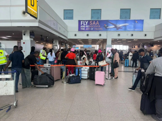 Travelers walking through an airport corridor in Nairobi, Kenya.