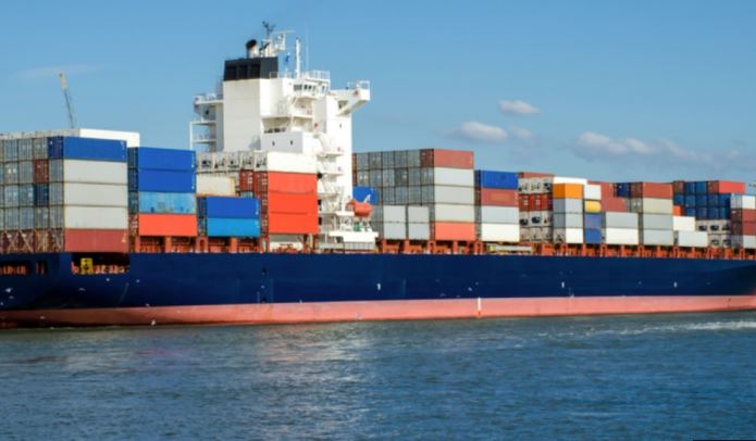 Large container ship navigating open coastal waters during daytime operations.