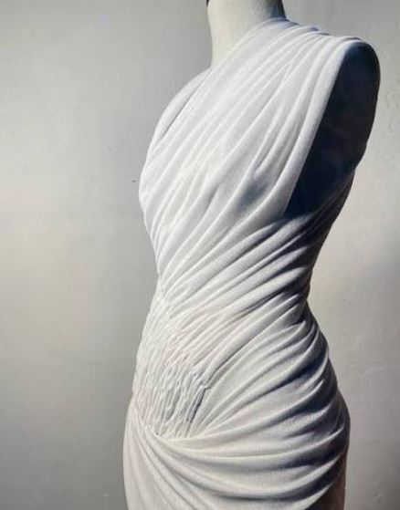 Elegant white silk fabric draped on a modern tailoring mannequin.
