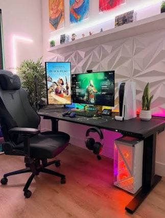 Modern home gaming desk setup featuring dual monitors, RGB lighting, and an ergonomic chair.