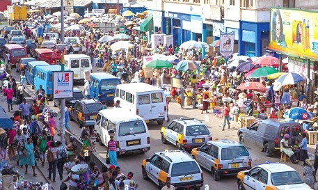 Busy commercial street scene in central Accra with commercial banking branches.