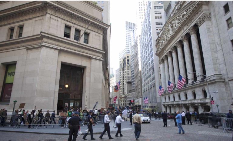 Street sign pointing toward Wall Street in downtown New York.