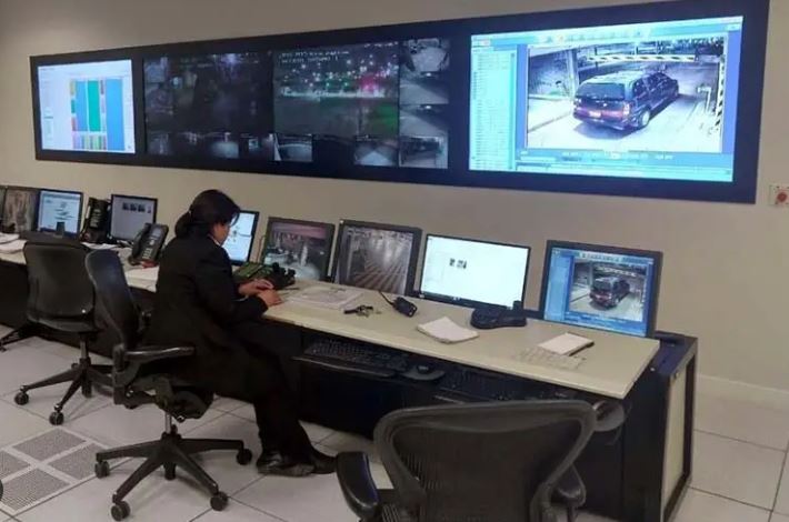 High-tech security operations center with multiple digital monitoring screens.