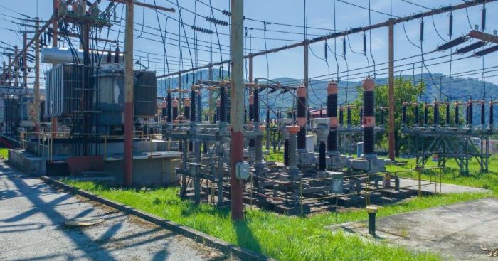 Electrical power substation with transformers and high-voltage switchgear.