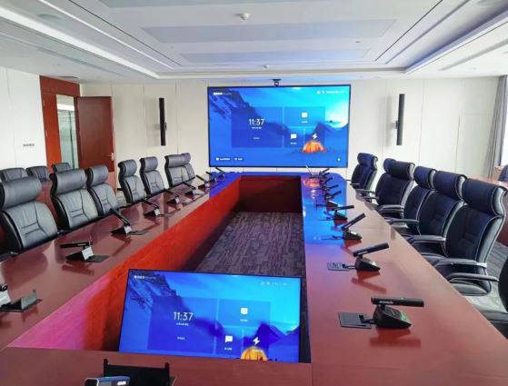 Modern corporate boardroom or executive conference room with individual microphone setups.