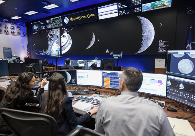 Scientific control room monitoring deep space telemetry feeds and telemetry data.